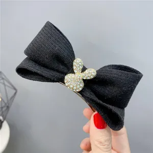 Black knit bow hair clip with rhinestone bunny charm, cute autumn winter hair accessory for women.