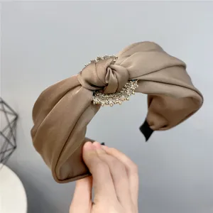 Elegant satin knotted wide headband with sparkling rhinestone embellishment for women.