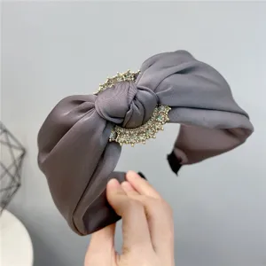 Elegant wide satin headband with crystal rhinestone buckle knot design for women detail view
