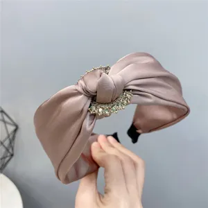 Elegant satin knotted headband for women, featuring sparkling rhinestones and chic wide design.