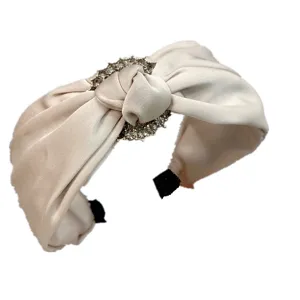 Close-up of a chic satin rhinestone knotted hair band, elegant accessory detail shot.