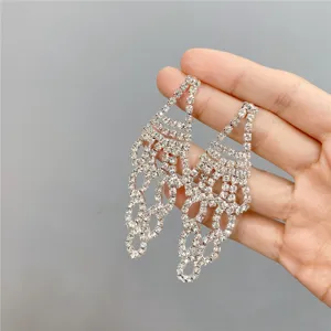 Close up of long rhinestone tassel earrings detailing sparkling crystal design and fine texture.