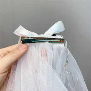 White double layer mesh hair clip with bow and LED lights for bridal and kids.