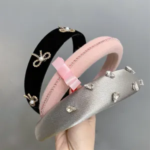 Set of three chic wide padded headbands featuring velvet, satin, rhinestone and bow details.