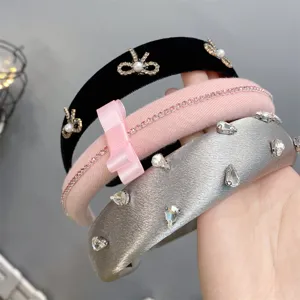 Detailed close-up of stylish wide hairbands featuring rhinestones, bows, and velvet textures.