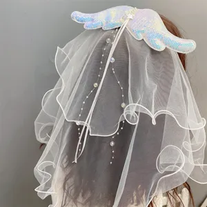 Angel wing mesh hair clip pearl veil detail shot showcasing sparkling sequins and elegant design.