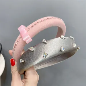 Close up detail of rhinestone velvet and satin wide headbands with cute bow design for women