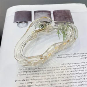 Clear acrylic cloud hair claw clip detail shot, featuring a stylish transparent design and spring.