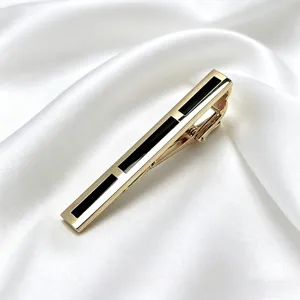 Men's luxury gold tie clip with black geometric enamel insert for business suits.