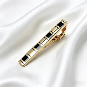 Close-up detail of the elegant gold metal tie clip featuring sleek black geometric inlaid design.