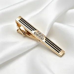 Men's business gold metal tie clip detail, featuring black stripes and rhinestones.