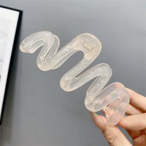 Transparent pink wavy hair claw clip, jelly resin large hair catch for women styling detail view.