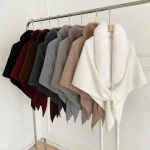 Detailed view of women's winter knit shawl cape featuring plush faux fur collar in multiple colors.