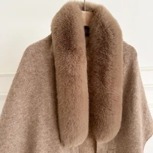 Close-up detail of the fluffy faux fox fur collar and soft knit texture on this warm winter cape.