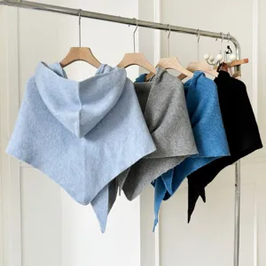 Detailed view of women knitted hooded triangular shawl poncho in multiple solid colors.