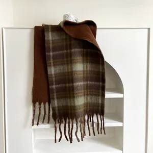 Detailed view of the thick warm plaid scarf with fringe, perfect for autumn and winter.