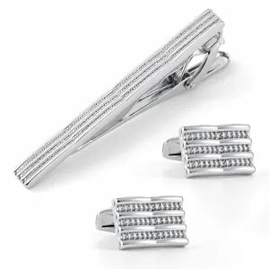 Silver tone metal tie clip and cufflinks set with textured pattern for men formal wear.