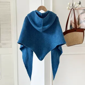 Blue knitted hooded triangular shawl detail showing the soft wool-blend texture and stylish design.