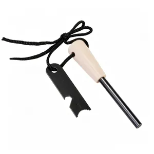 Detail close-up of outdoor survival fire starter with wooden handle and metal striker tool.