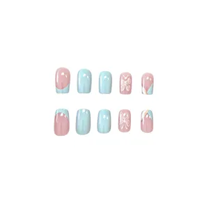 Close-up detail of blue and pink French press-on nails with cute butterfly pattern.
