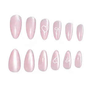 Pink cat eye long almond press on nails with cute heart and bow detail, ideal for daily wear.