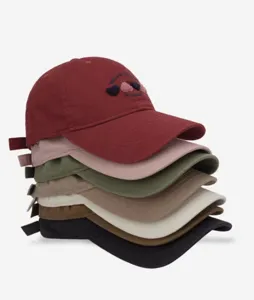 Detail view of stacked baseball caps, featuring embroidered heart patterns for casual wear.