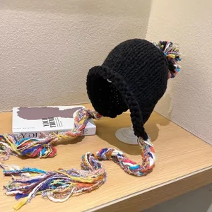 Black knit beanie hat with colorful braided tassels and pom-pom winter warm fashion cap
