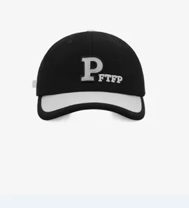 Detailed shot of the black and white baseball cap featuring P letter embroidery and short brim.