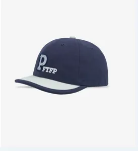 Navy blue baseball cap detailed view, showing front embroidered P and FTFP letter design.