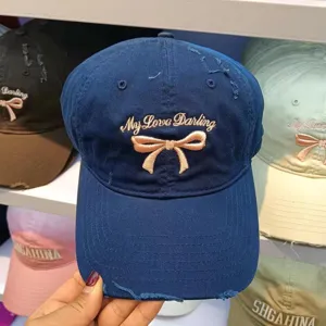 Detailed view of the Korean sweet bow embroidered baseball cap in navy blue cotton.
