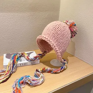 Pink knit beanie with colorful braided tassels and pom-pom for women autumn winter warmth.