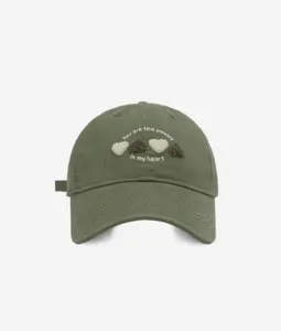 Olive green cotton baseball cap featuring cute embroidered heart patterns and English text detail.