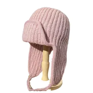 Stylish pink knitted trapper hat with cozy earflaps and chin straps for autumn winter warmth.