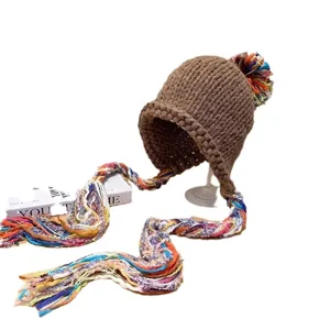 Chunky knit beanie hat with colorful braided tassels, stylish warm pullover headwear.