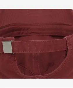 Close-up view of the adjustable metal buckle and strap on the back of a solid burgundy cap.