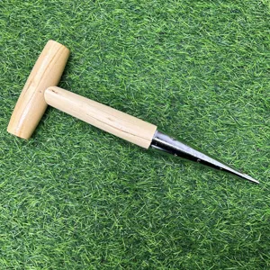 Detail view of a T-shaped wooden handle garden dibber tool with metal depth scale tip for planting.