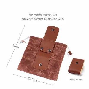 Détail du sac de rangement pliable en toile montrant les dimensions et format compact.