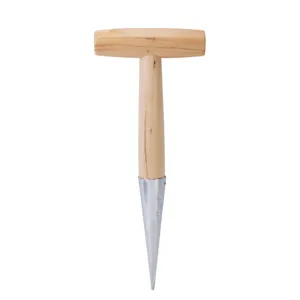 Close up of garden dibber metal tip and wooden handle for precise hole punching and seed sowing.