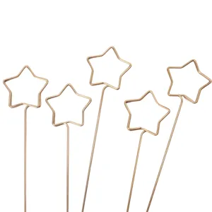 Close-up shot of metal star card holders showing detailed wire craftsmanship and pick design.