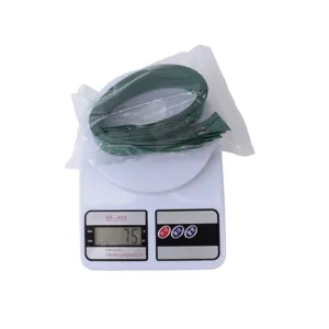 Detalle de correa de nailon verde para árboles con ojales metálicos para soporte de plantas.