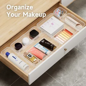 Clear plastic drawer organizer set for cosmetics, cutlery, and sundries desktop storage.