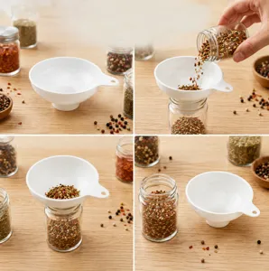Detail view of white plastic kitchen funnel used for dispensing spices and dry goods easily.