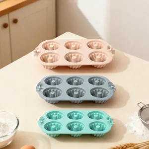 Silicone 6-cup baking mold detail showing flexible pastel trays on modern kitchen counter.