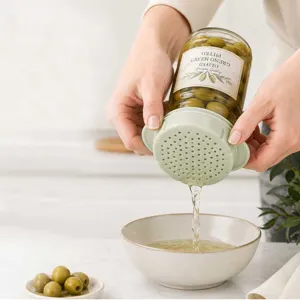 Silicone can strainer lid for kitchen food draining, easy to use green olives jar drainer tool.