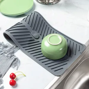 Grey foldable silicone drying mat for kitchen sink, heat-resistant tableware draining pad.