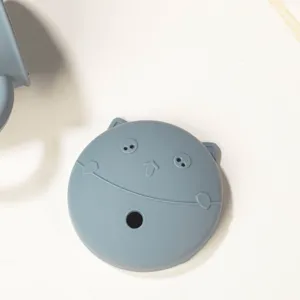 Silicone cup lid with cute cat face design and straw hole, flexible food-grade material.