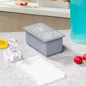 Detail shot of grey silicone ice cube mold with white lid on kitchen counter for easy use.