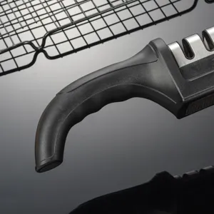 Detail view of handheld knife sharpener with ergonomic black handle and slots for kitchen
