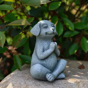 Meditating dog statue detail shot, resin Zen puppy sculpture for home and garden decor.