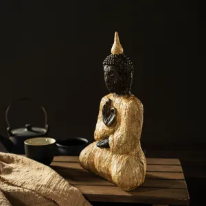 Detailed view of wood-grain sitting Buddha resin Zen ornament for peaceful home decor.